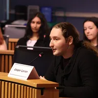 A person speaks into a microphone.