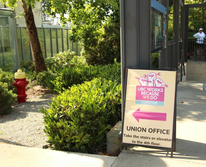 A sign posting towards CUPE 2278's office at the UBC Vancouver campus.
