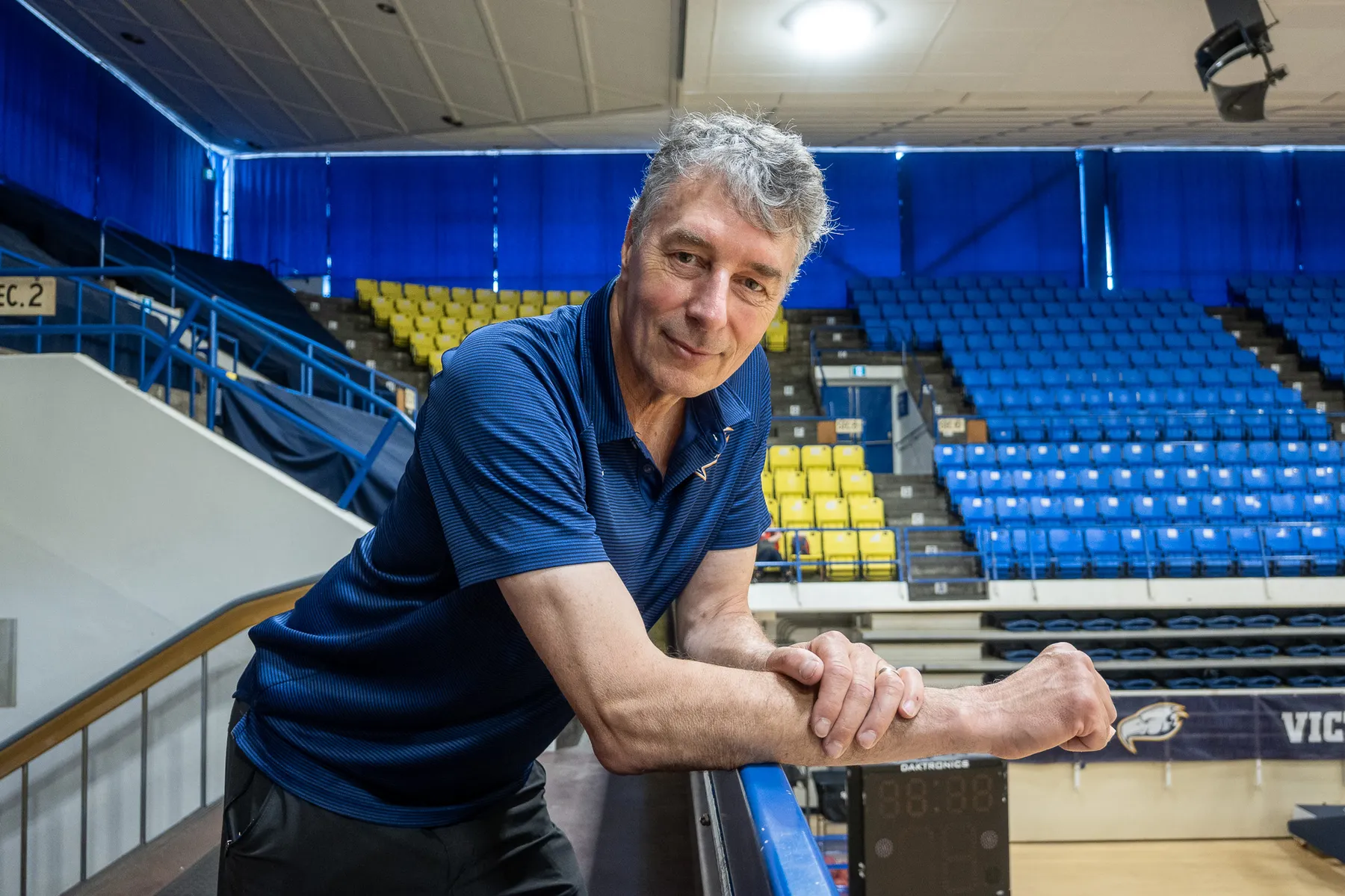 Reimer leans over a railing in War Memorial Gym.