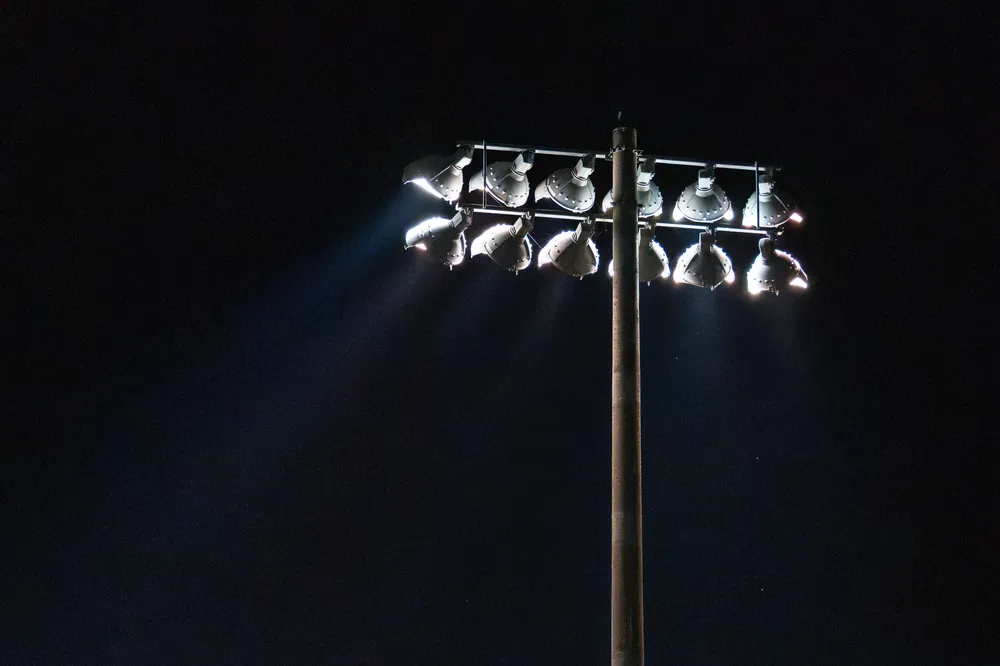 The stadium lights turned on after the sun set on Thunderbird Stadium, lighting up the field.