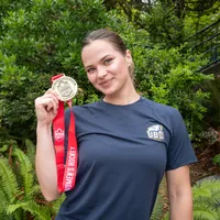 Markova holding a gold medal from the Canada West championship.