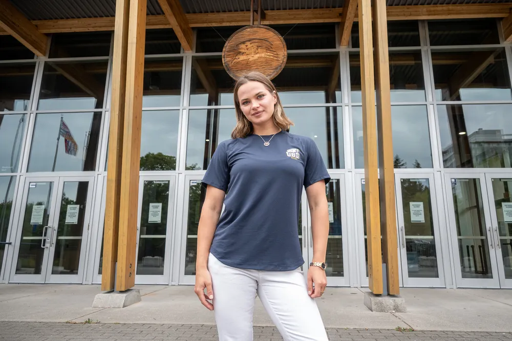 Markova standing in front of the Doug Mitchell Thunderbird Sports Centre.