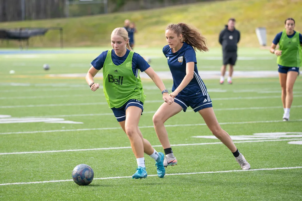 UBC Thunderbirds' players chasing the ball during a women's soccer practice.