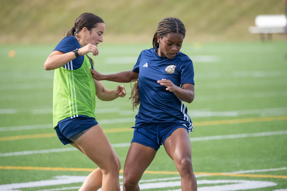 Two UBC players practising on the field.