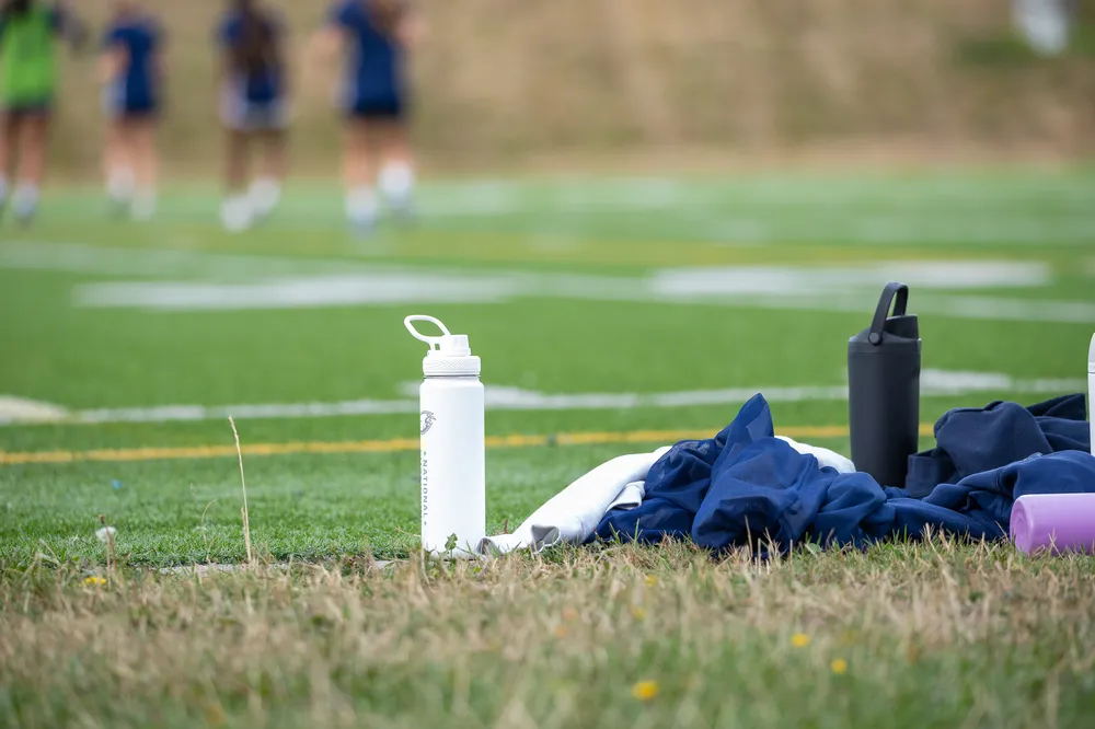 Water bottles on the sideline as the players practice.