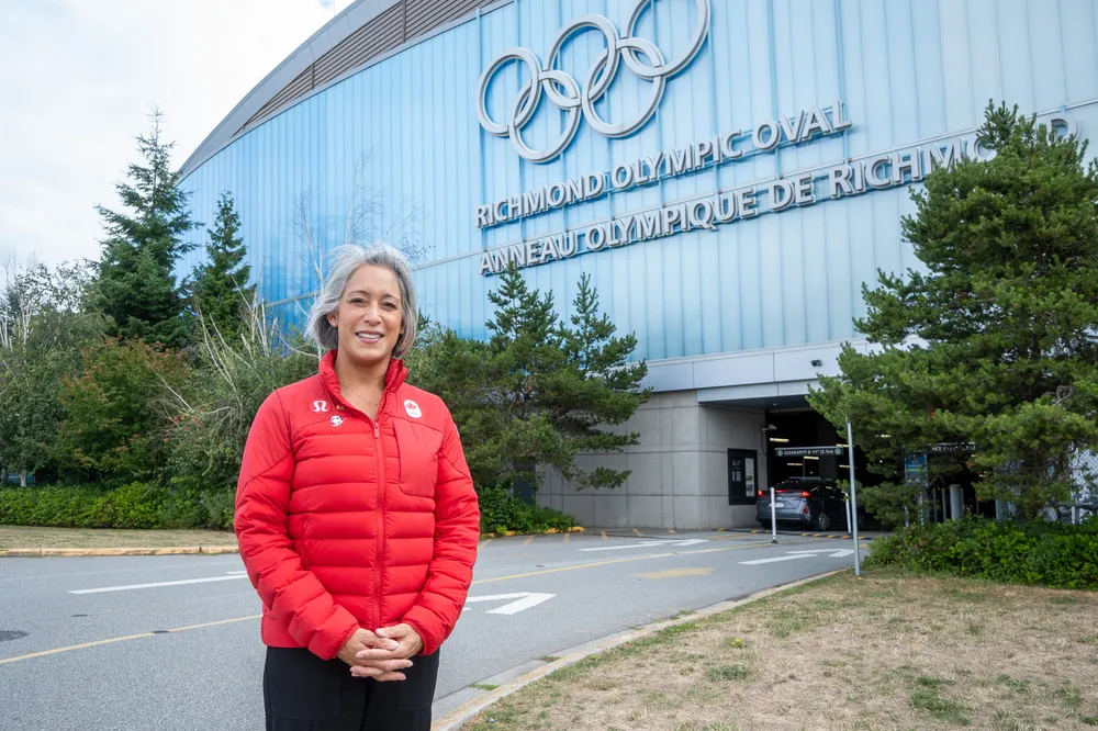 Loo standing in a Team Canada jacket, outside of the Richmond Olympic Oval