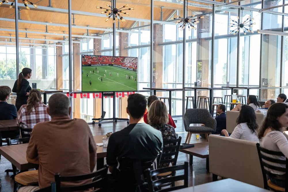 People gather in the Gallery at UBC to watch a World Cup game.