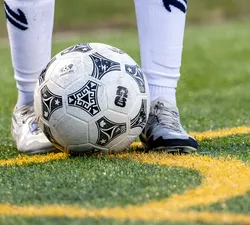 A close up of a soccer ball on a grass field.