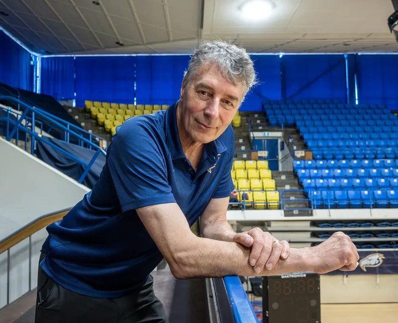Reimer leans over a railing in War Memorial Gym.