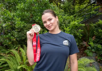 Markova holding a gold medal from the Canada West championship.
