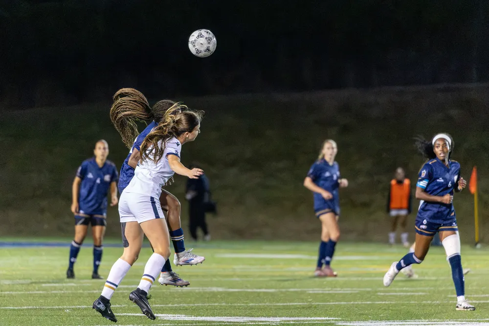 UBC and TWU compete for a header.