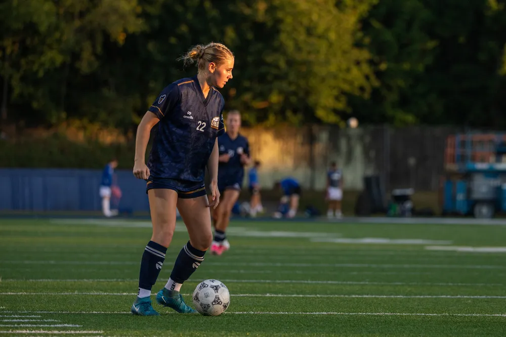 A T-Birds player stands alone with the ball at her feet.