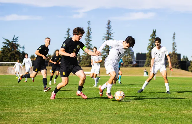 UBC players dominate the ball on the field against UAlberta