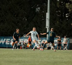 UBC midfielder alone trying to get pass the Spartans'defence.