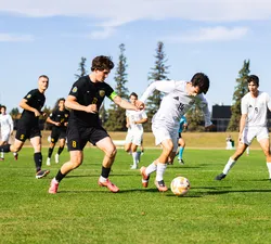 UBC players dominate the ball on the field against UAlberta