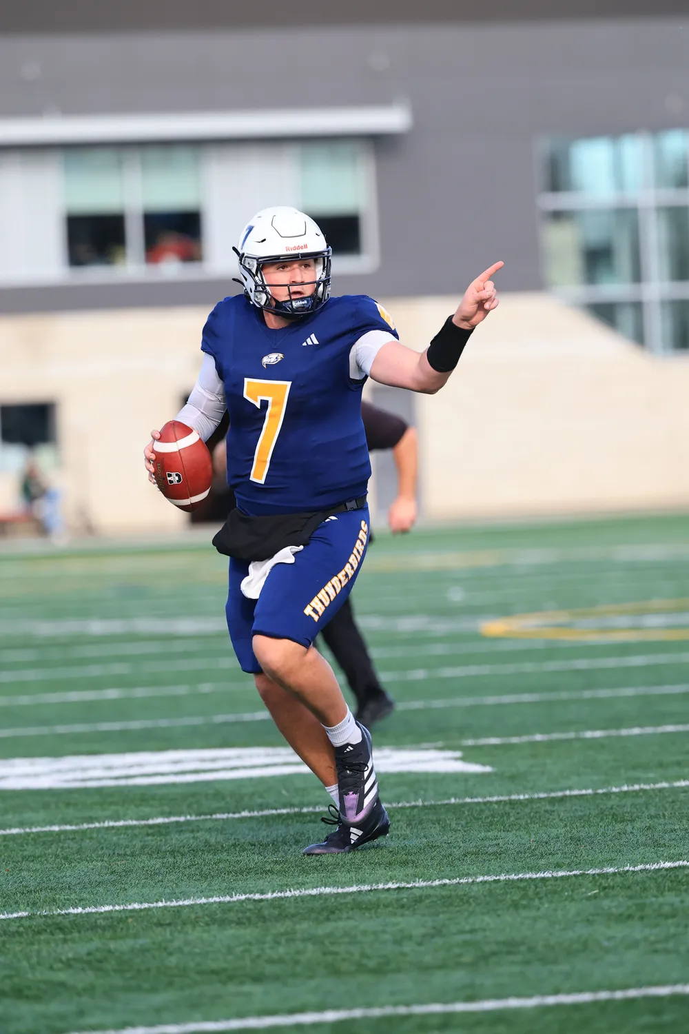 Viotto points down field as he rolls out of the pocket, ball in hand.