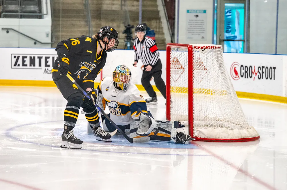 A Waterloo player breaks in on goal alone, with only Hugens in the way of a goal.