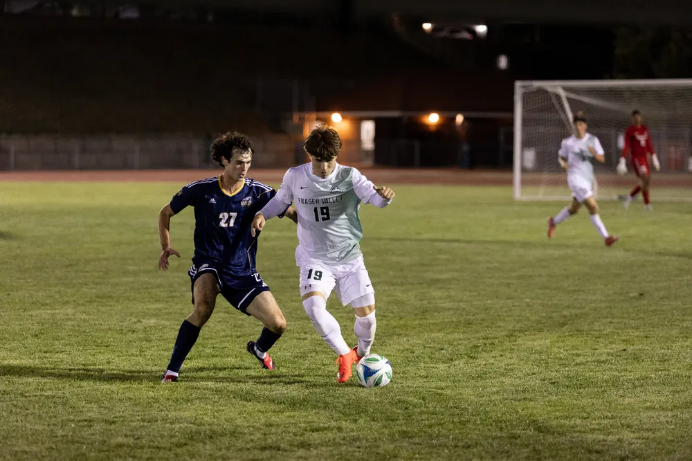 Rukavina approaches a defender, attempting to steal the ball.