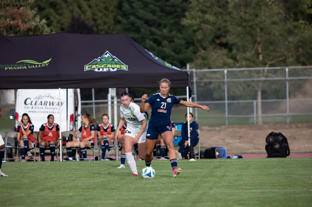 UBC #21 evades her defender off the dribble.