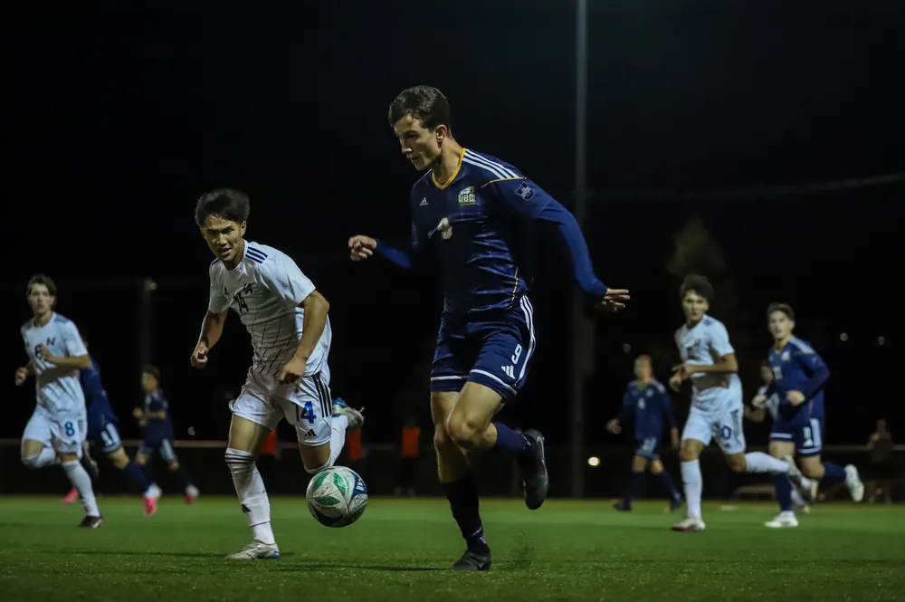 A UBC player chases down the ball while Heat players give chase.
