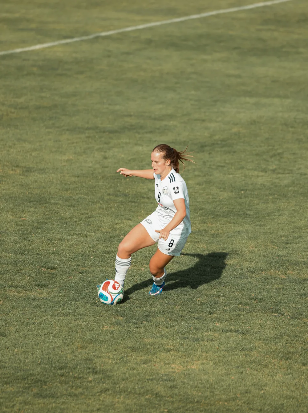UBC player alone with the ball on the field.