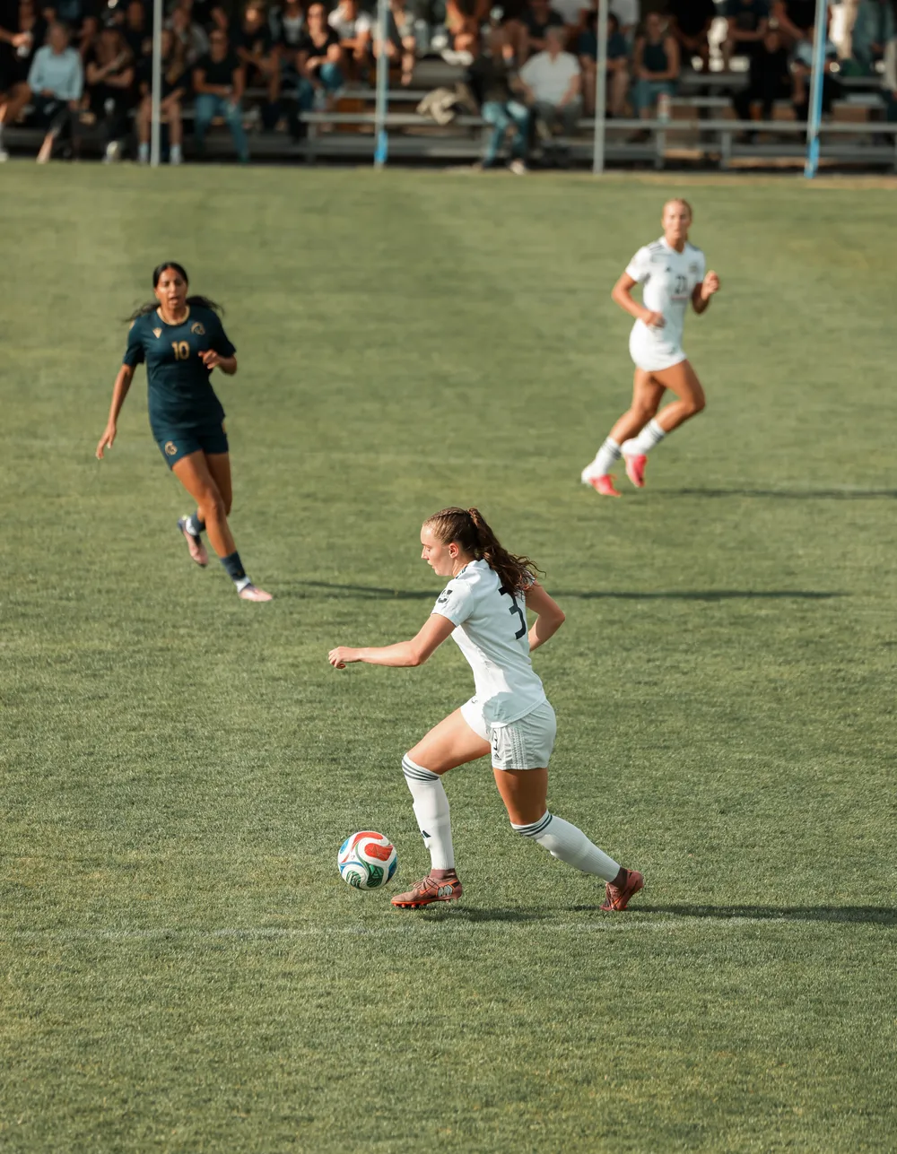 UBC player dribbles past a Spartan defender.