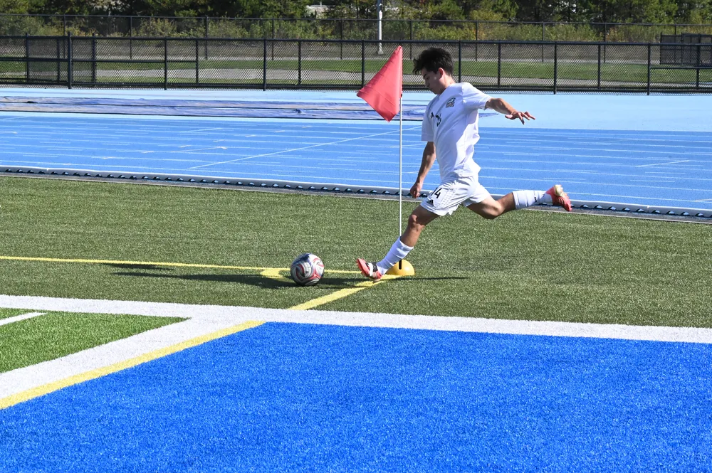 A UBC player sets up for a corner kick