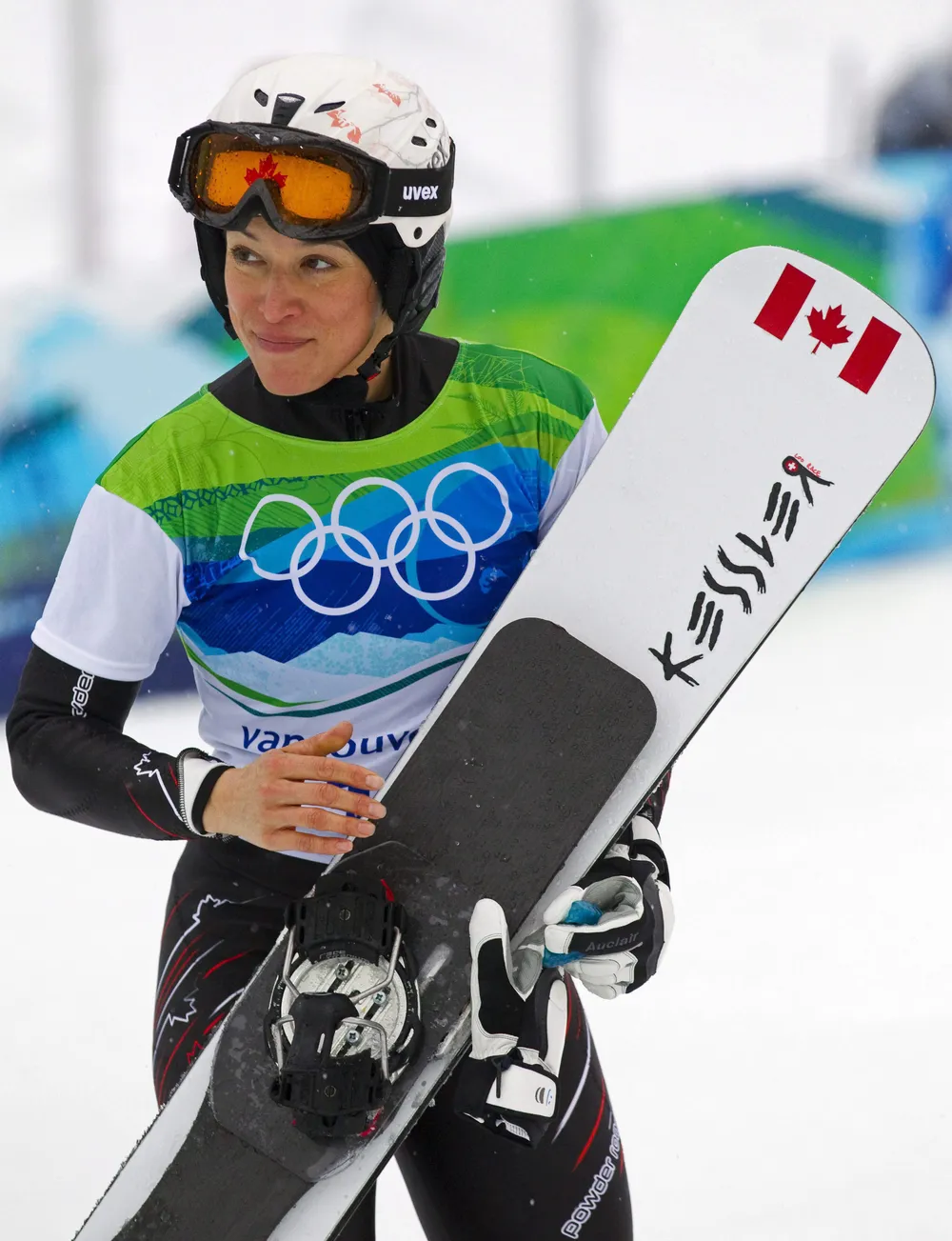 Loo stands with her snowboard during the 2010 Olympic Winter Games in Vancouver