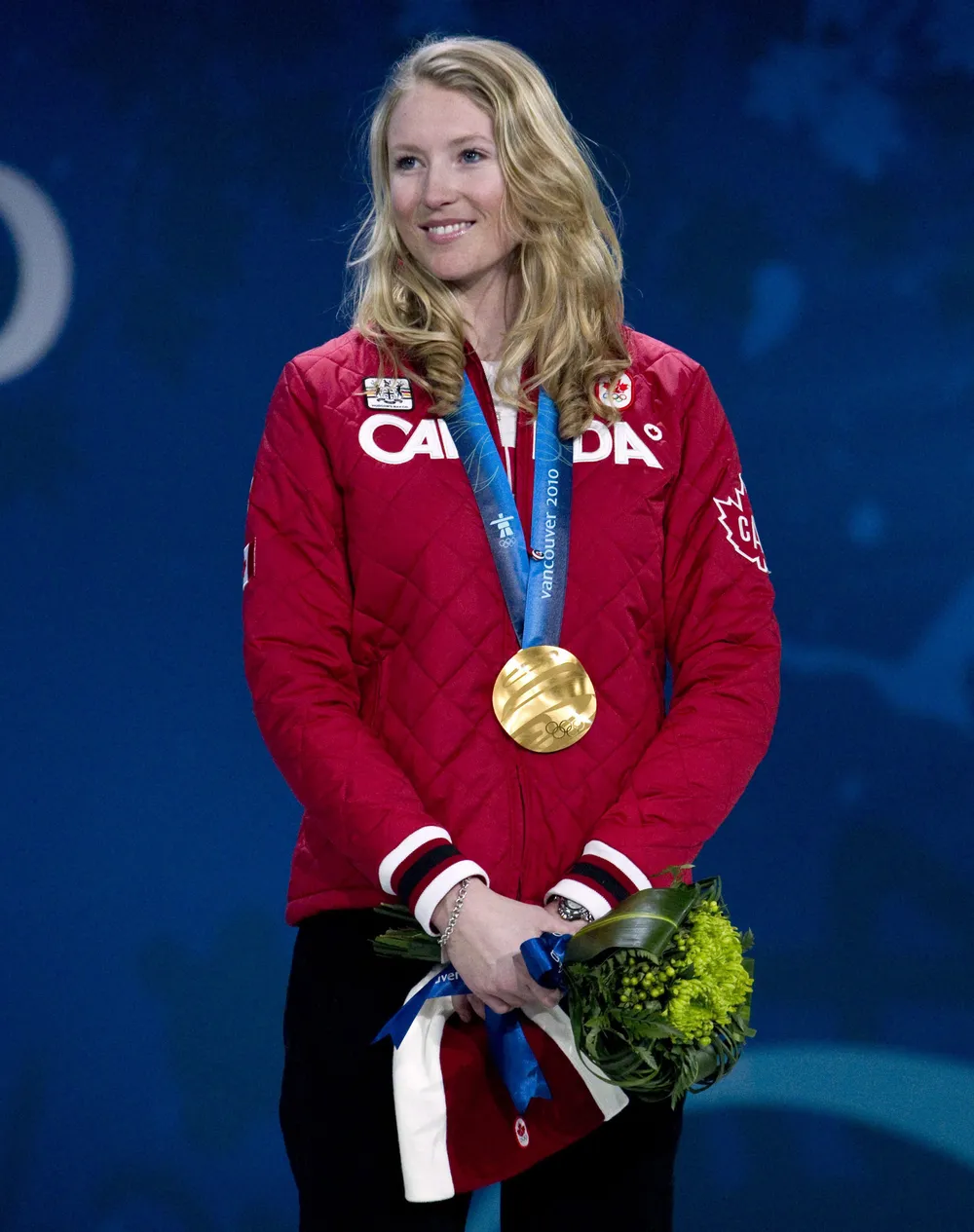 McIvor stands on the podium after winning the first-ever ski cross Olympic gold medal.