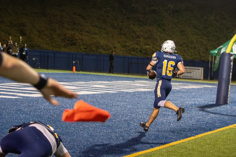 Kanagawa runs into the end zone as a flag is dropped on the field.