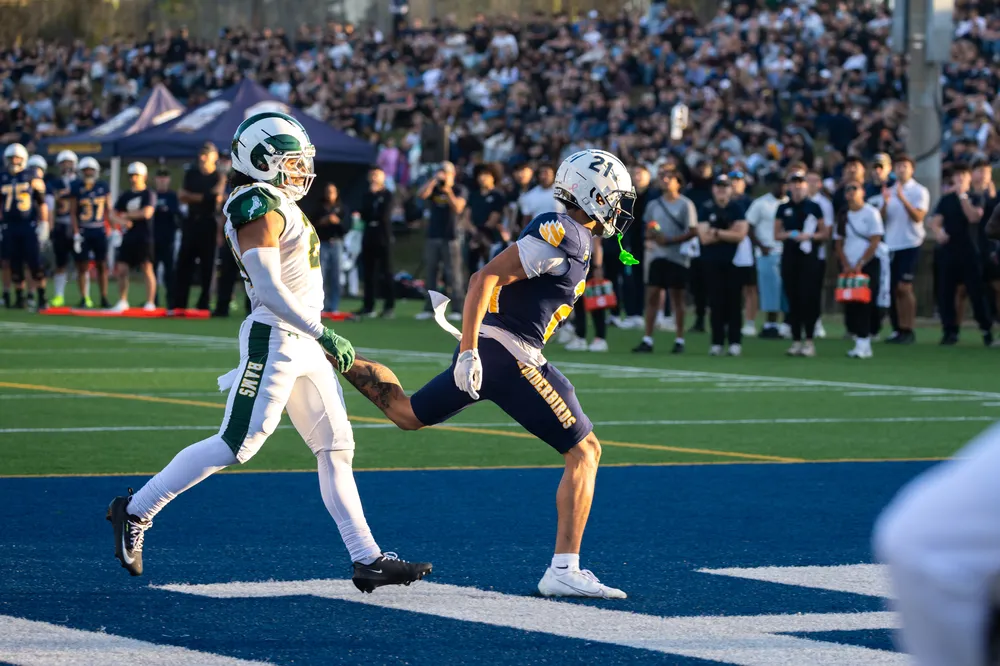 Receiver Trey Montour (#21) runs through the end zone during the game.