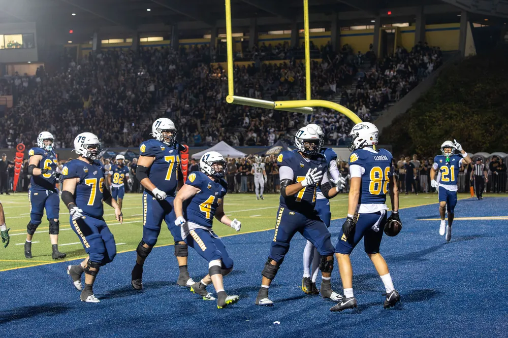 Tight end Santiago Llarena is celebrated after scoring his first touchdown as a Thunderbird.