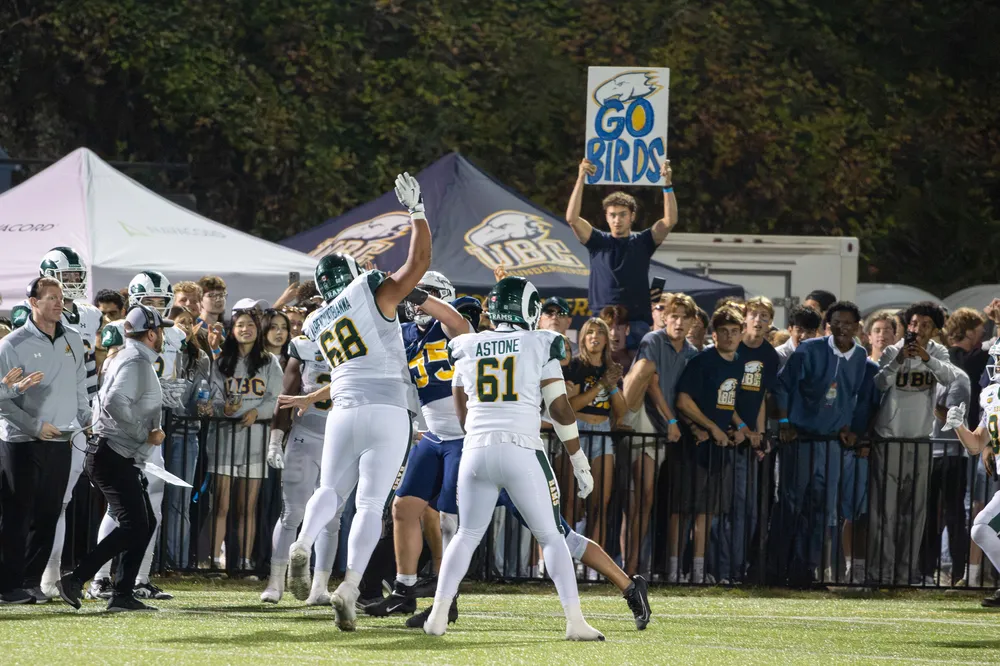 UBC fans hold up a “Go Birds” sign behind Regina players.