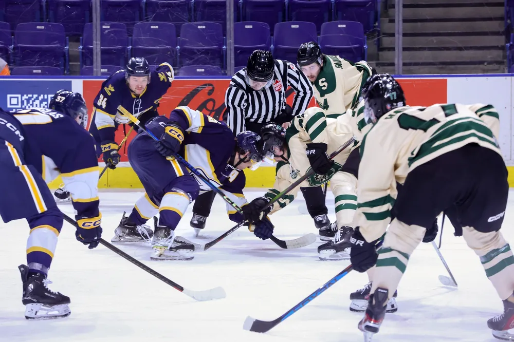 UBC and Saskatchewan line up for a faceoff.
