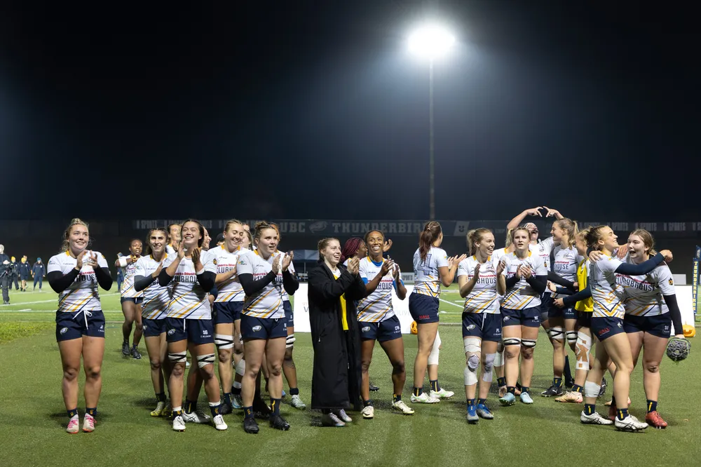 UBC's players celebrate on the field together after beating Queens in the semifinals of the 2025 national tournament.
