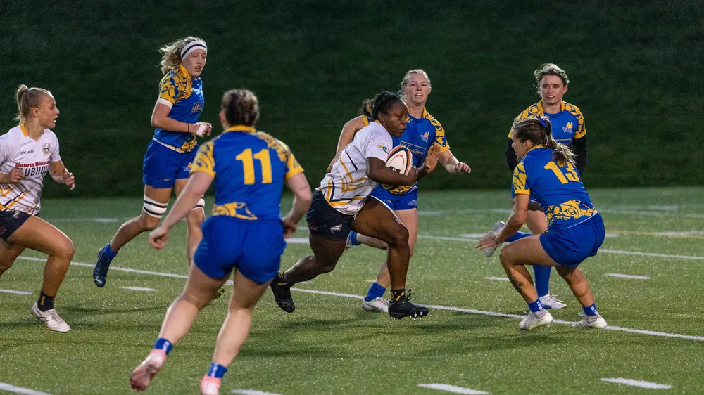 Idowu takes off with the ball, running through multiple Victoria defenders.