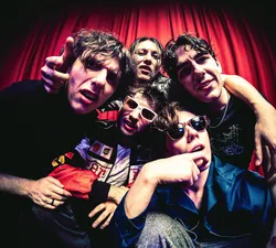 The five members of Chopping Spree stand in front of a red curtain, shot from below using a fisheye lens.