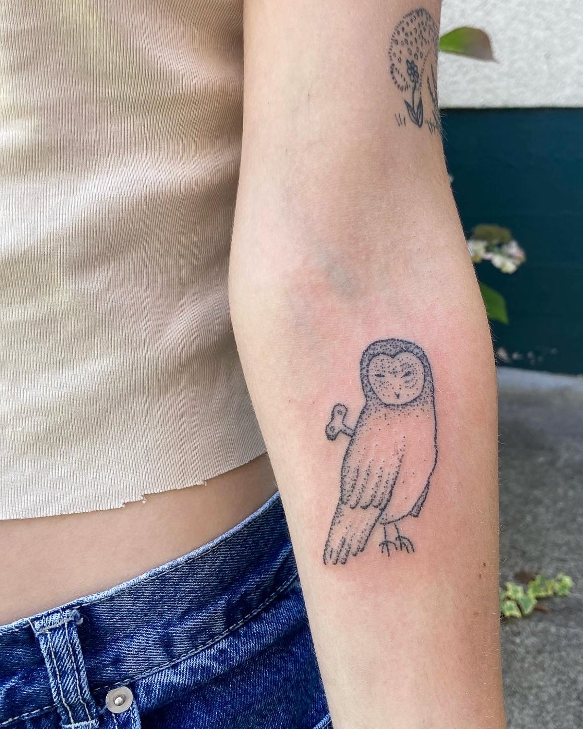 A tattoo of a wind-up owl by Clara Sismondo.