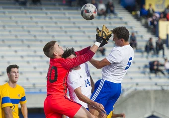 UBC's Conor Guilherme and Ryan Arthur scramble with Vikes keeper Maxwell Branyik-Gil.