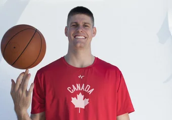 Connor morgan awkwardly poses with a basketball.