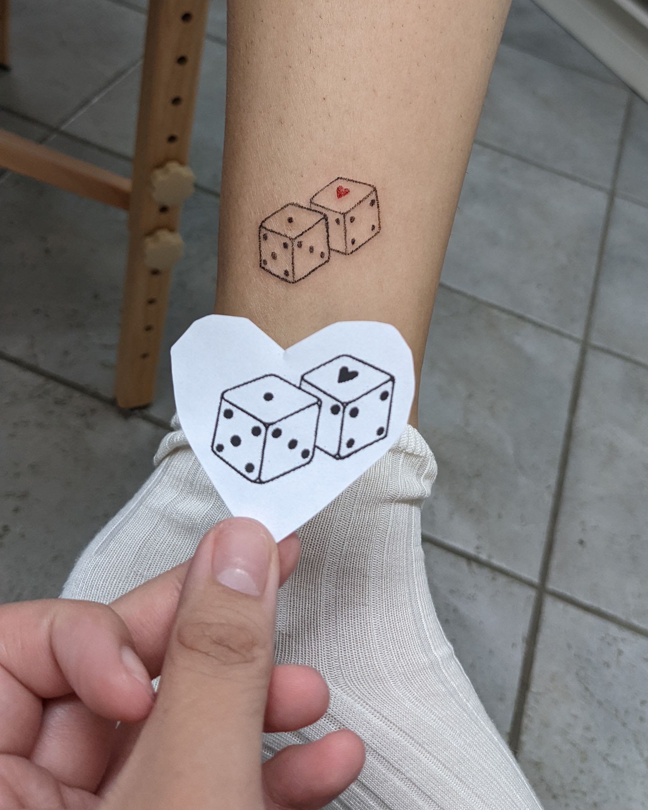 A tattoo of dice by Li Yang
