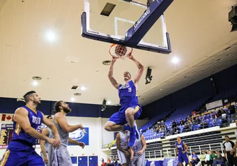 Connor Morgan dunks during a game against the Bishops, October 2017