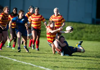 Alberta makes a pass while UBC attempts a tackle, 13 October 2017 Womens' Rugby