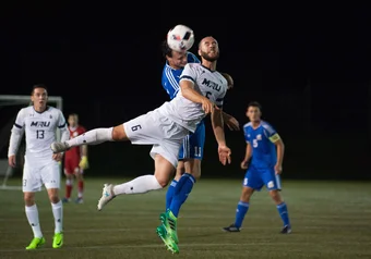 Mount Royal #5 deflects the ball with a header. Canada West playoffs, Mens Soccer, 27 October 2017