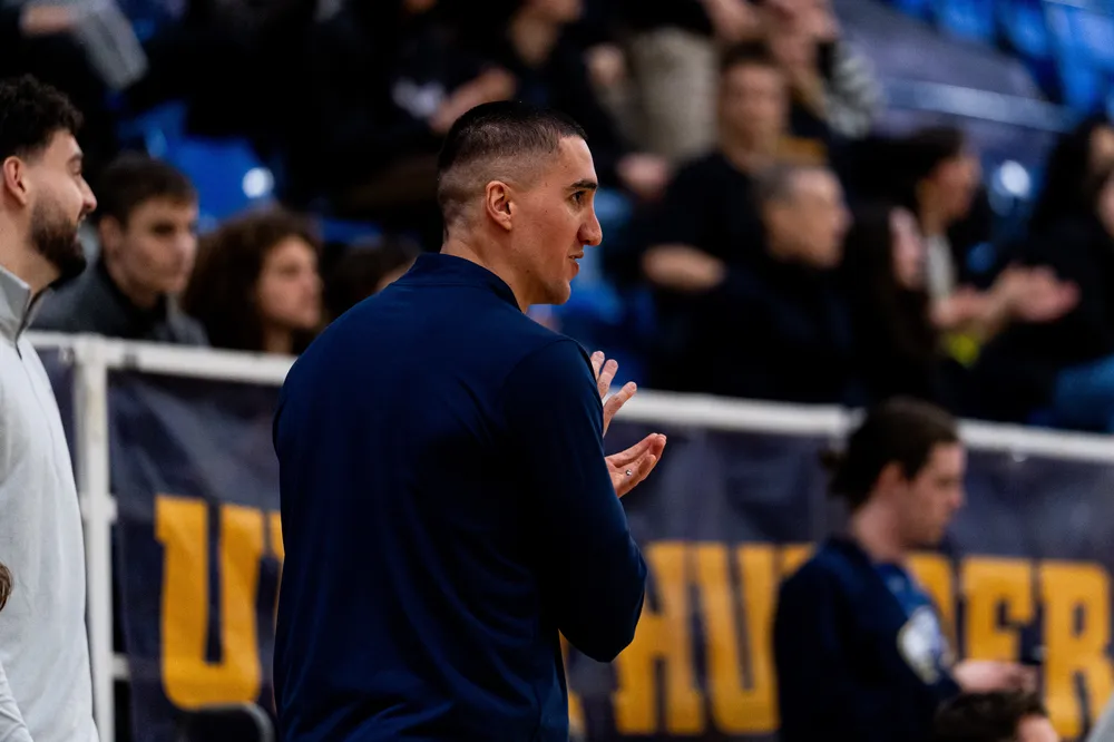 Jalalpoor applauds on the sideline while his team plays on.