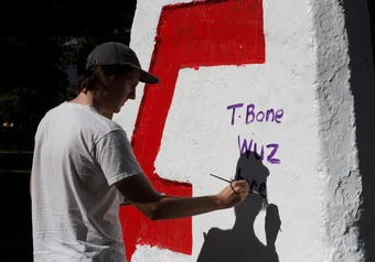 Tristan paints the Cairn.