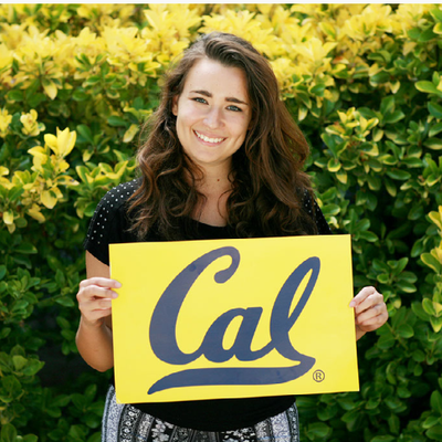 Student holding Cal sign