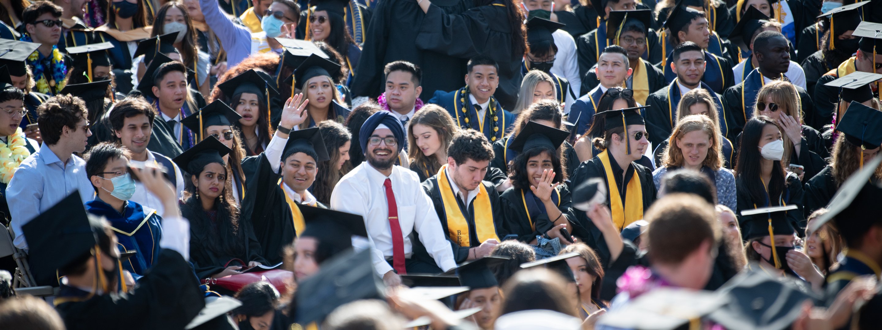 photograph of a happy crowd at commencement ceremony