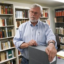 Bob Hirst in a room full of bookshelves