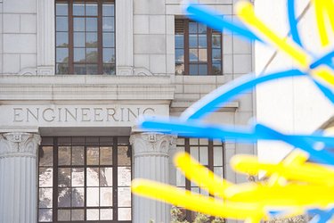 image of engineering building facade with blue and gold balloons in foreground